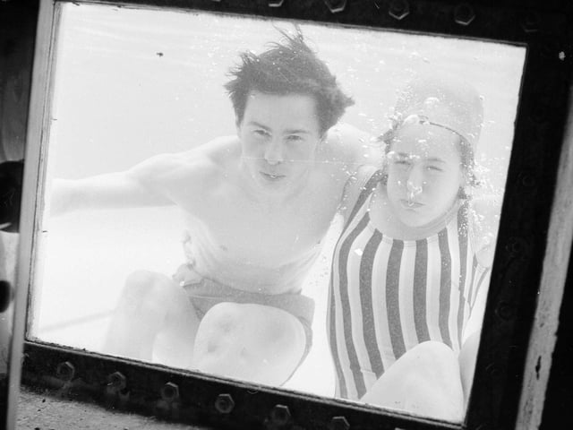 Bathers John Charity and Susan Kelman look through the observation window at Portobello Outdoor Swimming Pool in 1964.