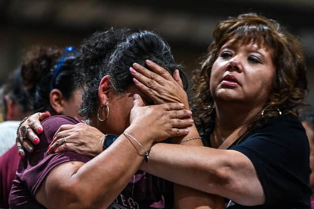 A woman in tears is comforted at a vigil for the victims of the mass shooting at Robb Elementary School in Uvalde, Texas (Picture: Chandan Khanna/AFP via Getty Images)