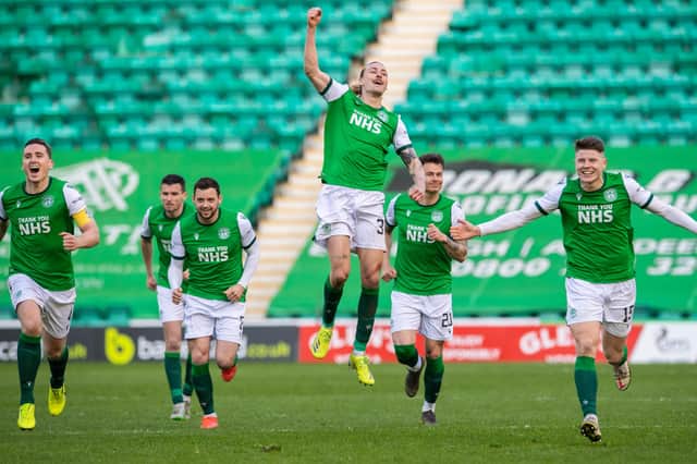Jackson Irvine leaps highest as Hibs celebrate winning the penalty shoot-out.