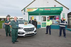 Rod Moore, pictured first left, helped so many people during his long career with the Scottish Ambulance Service and even took the time to praise other people's live saving efforts as he did here back in March - applauding Stenhousemuir's Day Today store after it installed a defibrillator