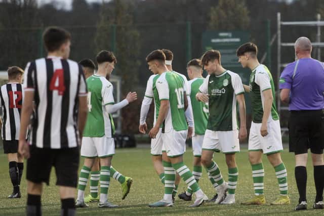 Reuben McAllister (far left), Jacob MacIntyre, and Josh Landers (far right) congratulate Jay McGarva after his second goal won the game for Hibs. Picture: Maurice Dougan