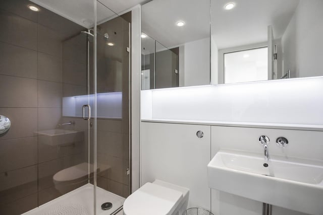 A large cubicle, attractive tiling and a mirrored unit are in place in the shower-room.