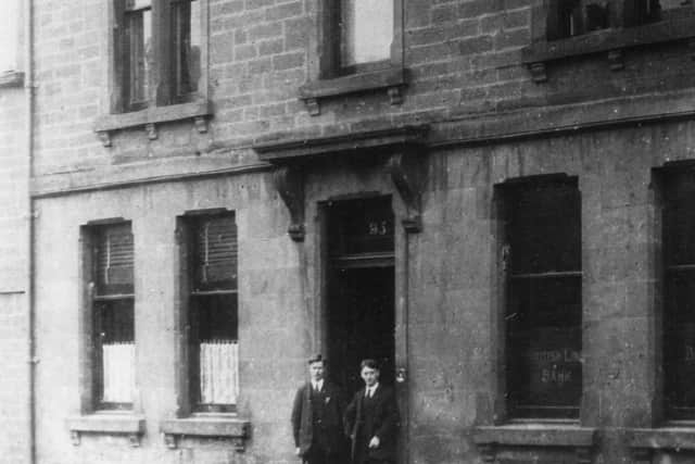 David Sharp (r) outside the bank while it was still the agent’s house c. 1916.