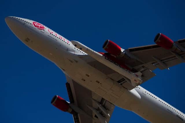The Virgin Orbit - a modified Boeing 747 - carries a Launcher One rocket under it's wing containing small satellites to be sent into space. (Pic: Getty)