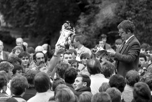 James Maclean, chairman of the Edinburgh Loyalist Coalition, reading as someone burns a copy of an Irish Republican newspaper during at rally at the Mound in October 1984.