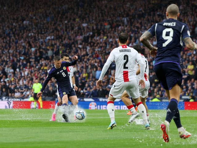 Callum McGregor splashes through the Hampden puddles to score Scotland's opening goal against Georgia (Picture: Ian MacNicol/Getty Images)