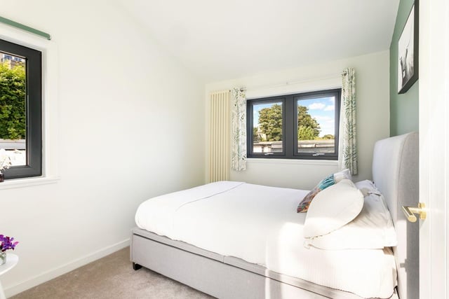 The two remaining bedrooms are both carpeted, and one is also enhanced by dual-aspect windows.