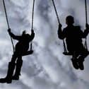 File photo of children playing on swings