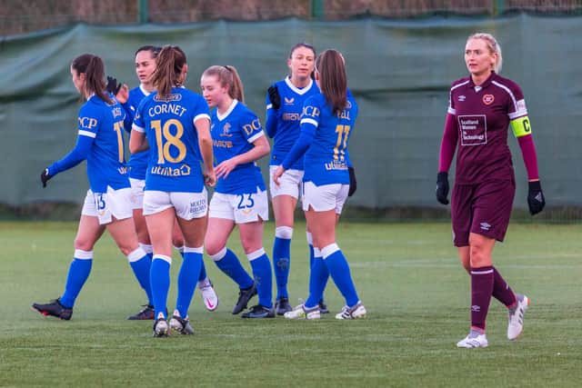 A disappointed Hearts captain Mariel Kaney trudges upfield as the Rangers players celebrate. Picture: David Mollison
