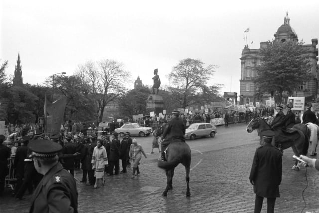 Mounted police and officers keep demonstrators back, waiting for Prime Minister Margaret Thatcher to arrive in Edinburgh to open the General Assembly of the Church of Scotland in May 1981.