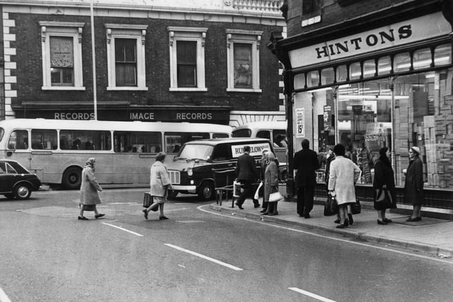 Shoppers outside Hintons in 1975. Does this bring back memories?