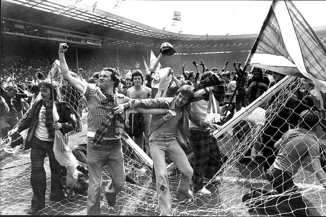 The photograph of triumphant Scotland fans invading the Wembley pitch in 1977. Picture: Denis Straughan