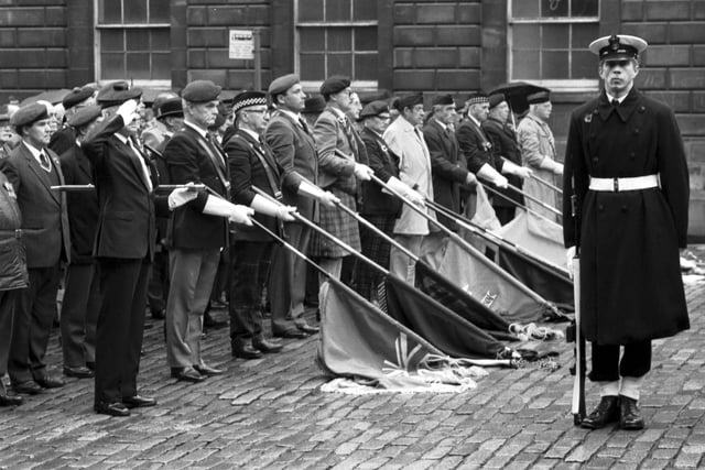 Members of the British Legion and Armed Services dip their flags in honour of former comrades who were killed in the Second World War at a Remembrance Day service outside Edinburgh City Chambers in November 1989.