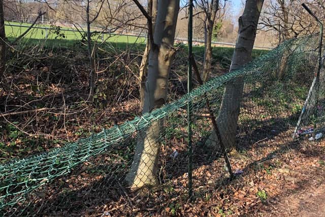 A fence that has been damaged by people trying to access the enclosure.