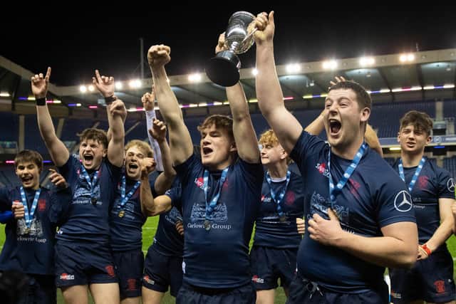 Merchiston Castle players celebrate with the trophy during at BT Murrayfield