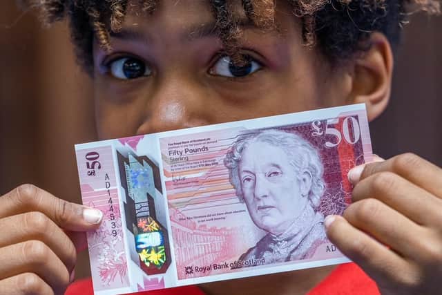 Dorian Silvera from Flora Stevenson Primary School in Edinburgh with the bank's new £50 note which features an illustration of Scottish education pioneer Flora Stevenson  (Photo: Royal Bank of Scotland/PA Wire).