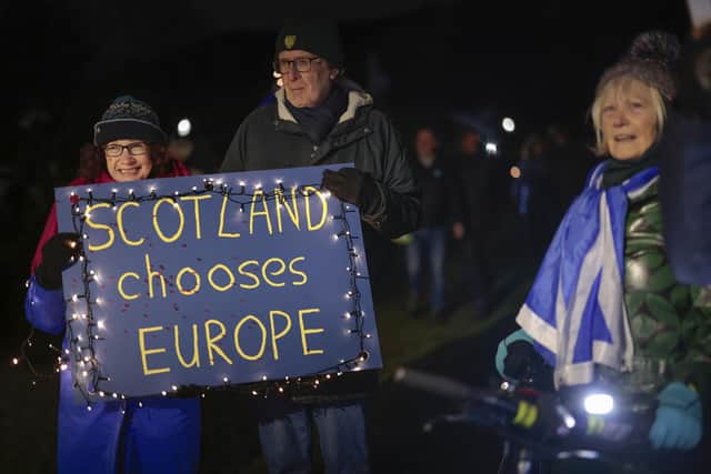Anti-Brexit campaigners take part in a torchlight procession to the Scottish Parliament on the third anniversary of Brexit on January 31 (Picture: Jeff J Mitchell/Getty Images)