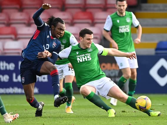 Regan Charles-Cook of Ross County battes fo the ball with Hibs' defender Paul Hanlon during the last meeting between the two teams