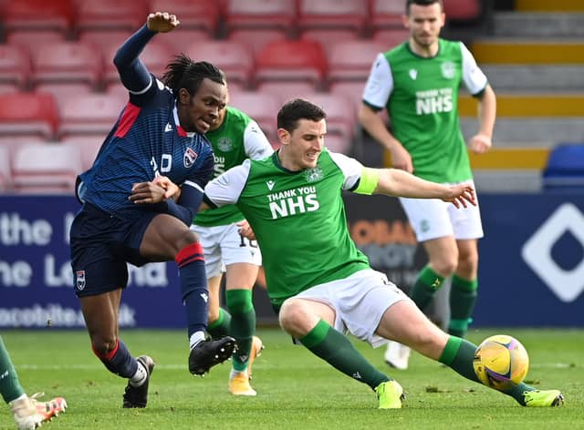 Regan Charles-Cook of Ross County battes fo the ball with Hibs' defender Paul Hanlon during the last meeting between the two teams