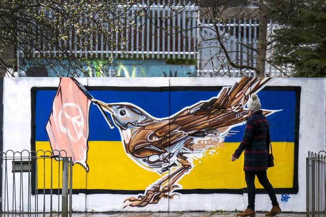 Solidarity: A new mural in Leith features a Nightingale, the official national bird of Ukraine, against the country's flag.  PIC: Jane Barlow/PA Wire