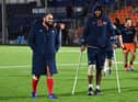 Viliame Mata, right, leaves the field on crutches with Edinburgh team-mate Lee-Roy Atalifo.  (Photo by Paul Devlin / SNS Group)