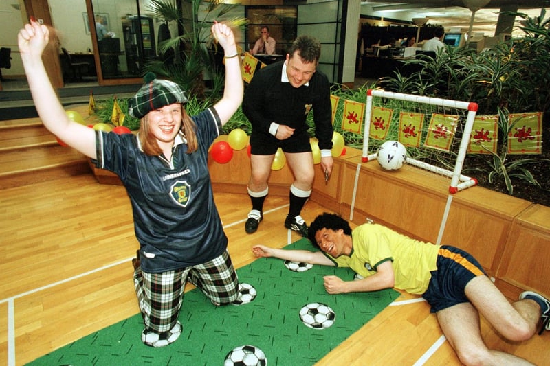 Staff at Standard Life's Stockbridge offices joined the World Cup fever in June, turning up for work in football strips and cheerleader outfits. The excuse for the football fiesta was development of team work. Leeann Kerr (20) is pictured scoring a goal for Scotland against Brazil's dejected goalie, Keith Serle (29) under the eye of referee James Dixson (32).