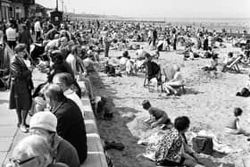 Children and families enjoy the sunshine on the beach and promenade at Portobello in 1975.