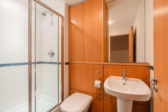 The master bedroom has this fully-tiled en-suite shower room with a double cubicle and heated towel rail.