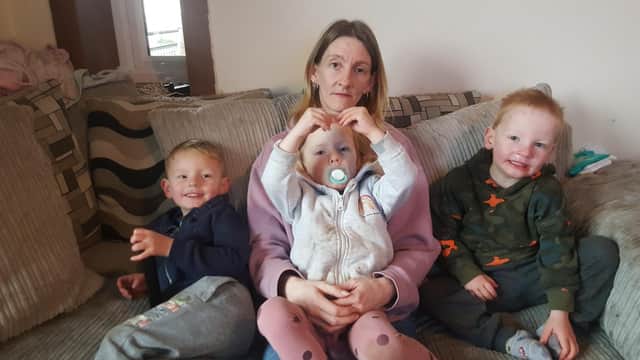 Susan Ferguson with her three young children who are covered in bites.
