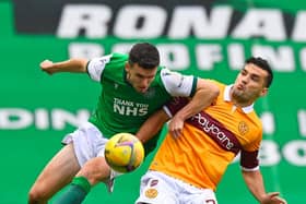Paul McGinn foils Motherwell striker Tony Watt. The Hibs defence is yet to concede a goal from open play