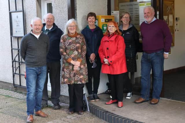 Pictured beside the publicly accessible defibrillator outside Dalkeith Library, are some of the people who have been involved in making this happen (from left to right - Douglas, Andrew, Ann, Rona, Margot, Evelyn, Colin).