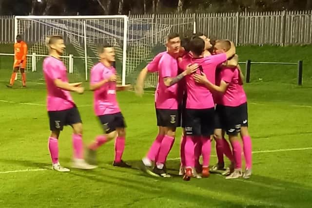 Tranent, all in pink, celebrate one of their seven goals at Whitehill Welfare