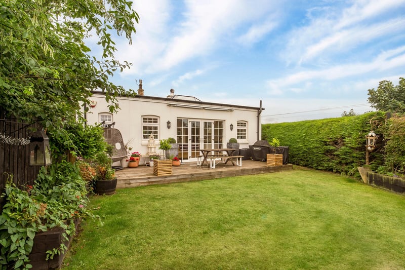 The fully enclosed rear southwest facing garden, which has a landscaped lawn and large decked area for alfresco dining/seating area. The front of the property has a secure gated patio area.