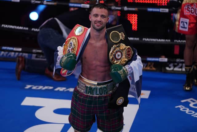 Josh Taylor shows off his IBF and WBA super lightweight world title belts after his win over Apinun Khongsong of Thailand. Picture: Queensberry