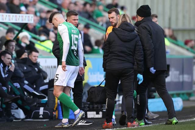 Nisbet leaves the pitch injured during the goalless draw with Celtic