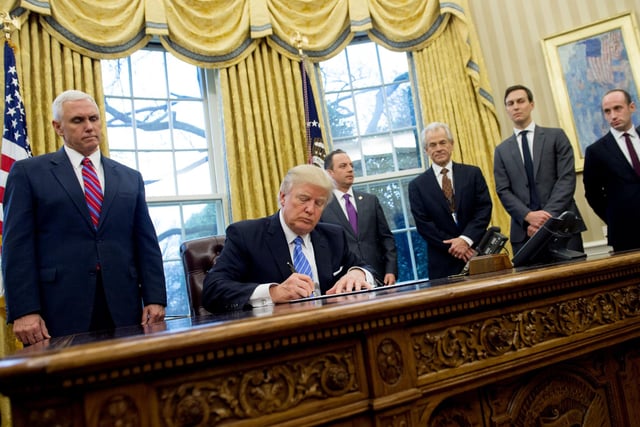 On his first day in office, President Donald Trump signs an executive order alongside White House Chief of Staff Reince Priebus (C), US Vice President Mike Pence (L), National Trade Council Advisor Peter Navarro (3rd R), Senior Advisor Jared Kushner (2nd R) and Senior Policy Advisor Stephen Miller in the Oval Office of the White House in Washington.  His Executive Order - witnessed by his male staff - was a ban on federal money going to international groups that perform or provide information on abortions.
