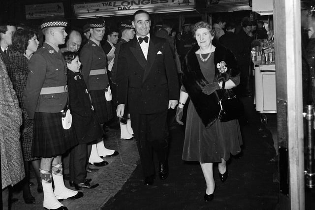 Hearts footballer Tommy Walker and his wife walk past a guard of honour at the premiere of film 'The Longest Day' at the New Victoria Cinema in February 1963.