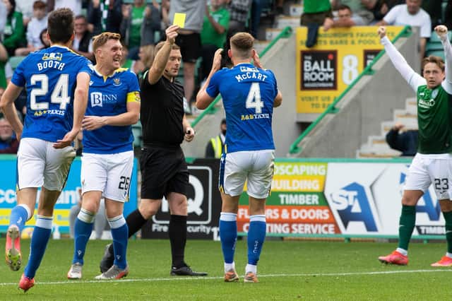 Referee John Beaton awards Hibs a penalty and books St Johnstone's Jamie McCart during the match at Easter Road. Picture: SNS