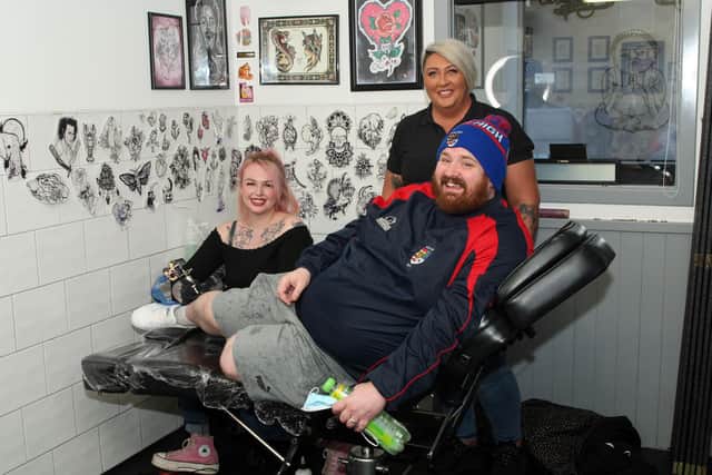 Derek Marr with tattooist Shannon Jamieson and Lynette Shields, owner of Nettie's takeaway