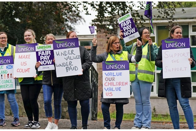 School support worker on the picket line at Holy Cross RC Primary School in Edinburgh. Essential school staff including cleaners, janitors and support workers have been locked in a pay dispute, with a new offer estimated to cost £580 million.