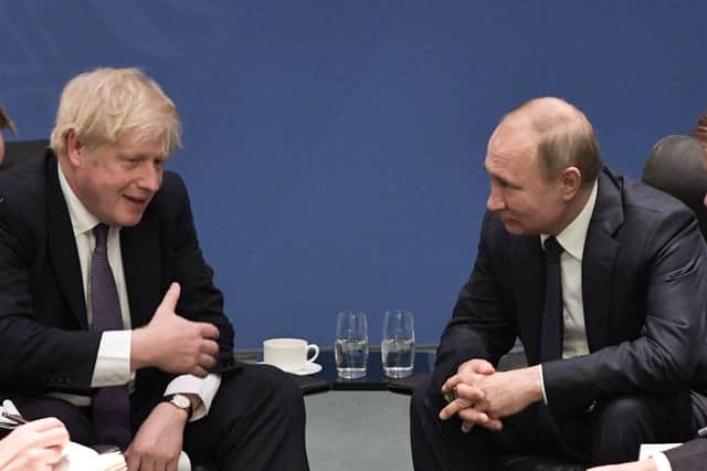 Boris Johnson and Vladimir Putin meet on the sidelines of a summit in Berlin in 2020 (Picture: Alexey Nikolsky/Sputnik/AFP via Getty Images)