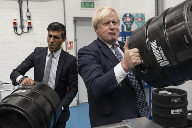 Boris Johnson and Rishi Sunak get the beers in during a visit to Fourpure Brewery in London. Photo: Dan Kitwood/PA.