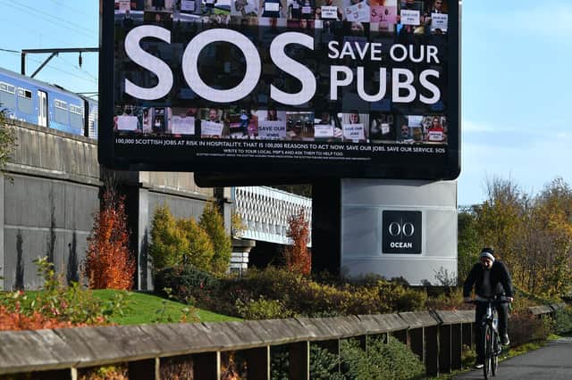 A billboard pleads 'SOS Save our Pubs' in an attempt to highlight the problems being faced by the hospitality industry amid the Covid outbreak (Picture: John Devlin)