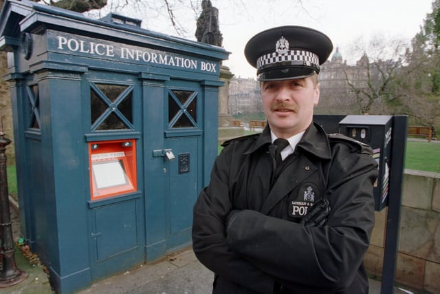 PC Robert Fairbairn pictured next to the Princes Street police box at the Mound in November 1998. He was demonstrating how to use the police box's newly installed touch sensitive information screen.