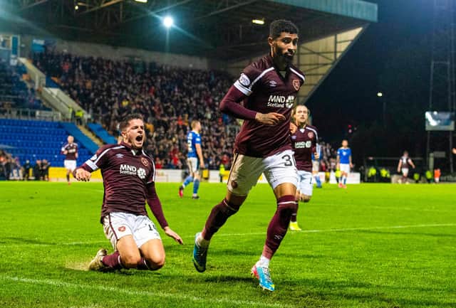 Josh Ginnelly leaves Cammy Devlin to a knee slide after scoring for Hearts at St Johnstone.