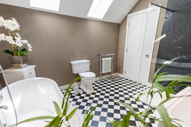 This is the master en-suite, with vibrant flooring and a roll-top bath.