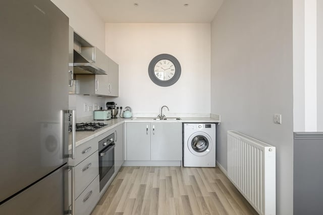 The fitted kitchen comes with a range of soft grey wall and base units 
Photo: Neilsons and Planography