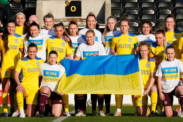 Both sets of players show support for Ukraine prior to kick-off. Picture: SNS