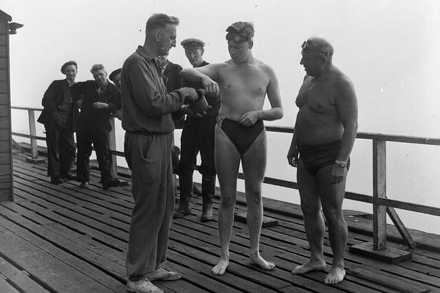 John Smith of Bathgate is coated with grease before swimming the Forth between Granton and Burntisland on 21st July 1955. He was accompanied by Channel swimmer Ned Barnie (right).