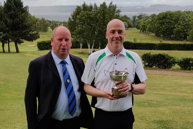 Graham Robertson, now a three-time Silverknowes champion, after receiving the trophy from club captain Alex Renton.
